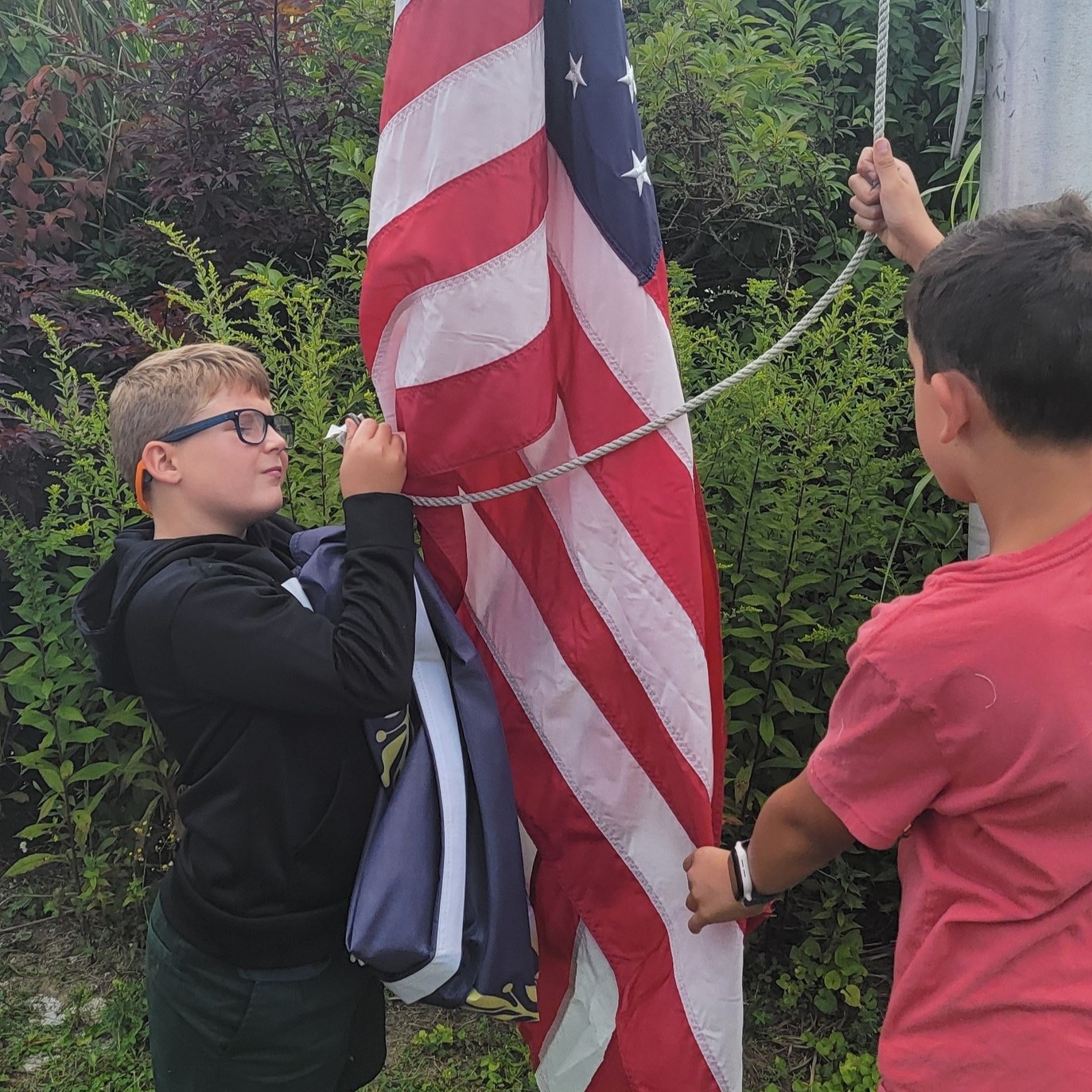 students hanging the flag